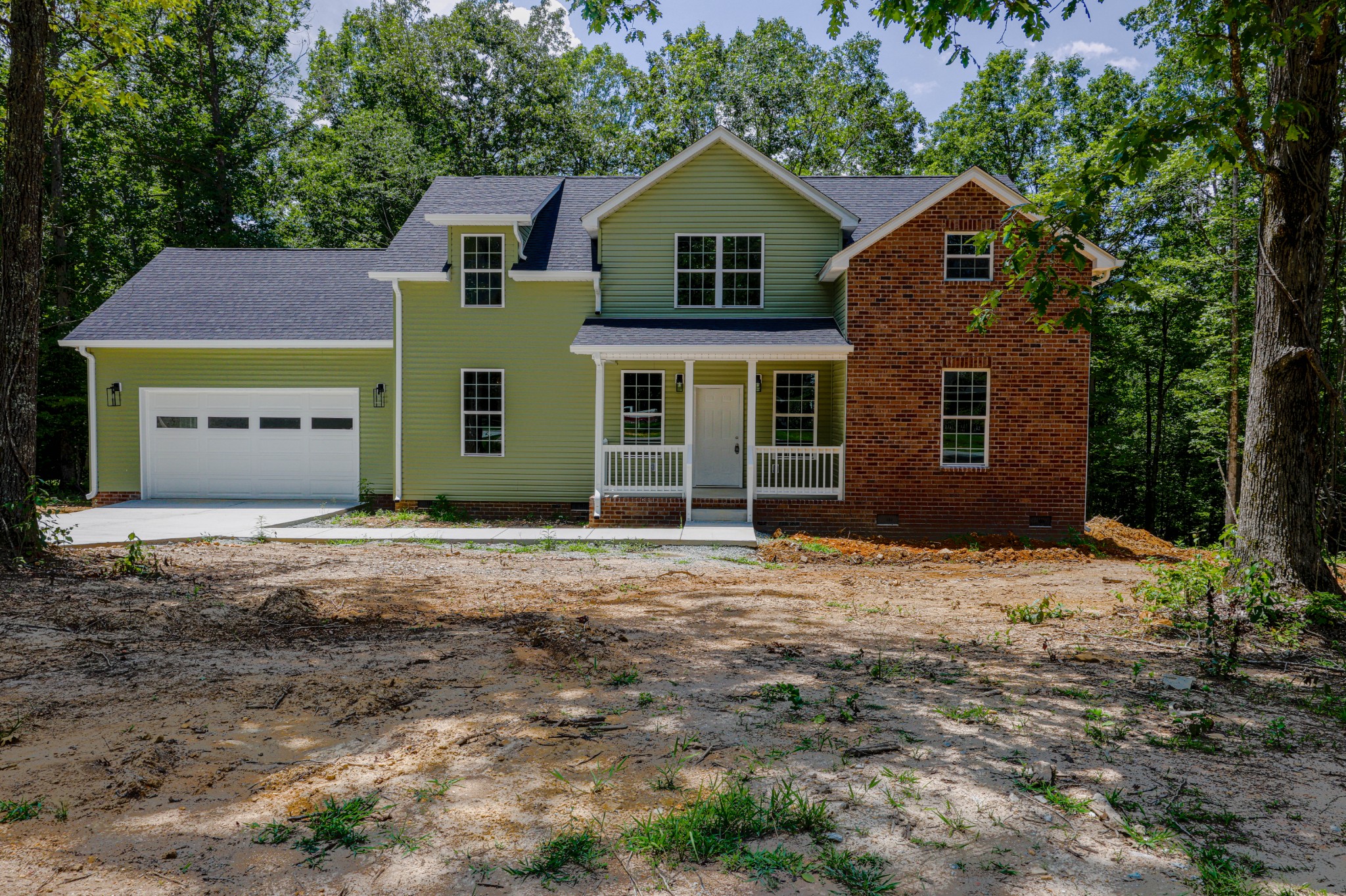 161 Vista Pointe Hohenwald, TN 38462 - Photo 3 of 43 a front view of a house with a garden