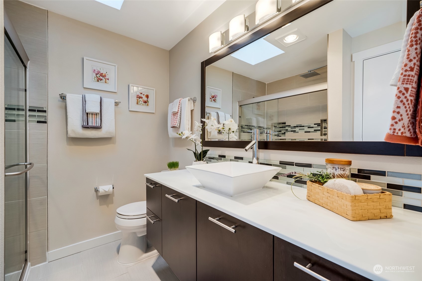 1110 West Howe Street, Unit 304 Seattle, WA 98119 - Photo 13 of 24 a bathroom with a sink and a mirror