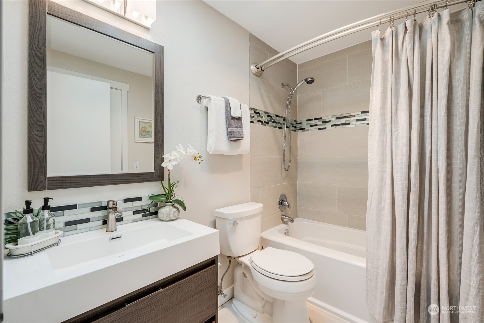 1110 West Howe Street, Unit 304 Seattle, WA 98119 - Photo 16 of 24 a bathroom with a sink toilet tub and shower