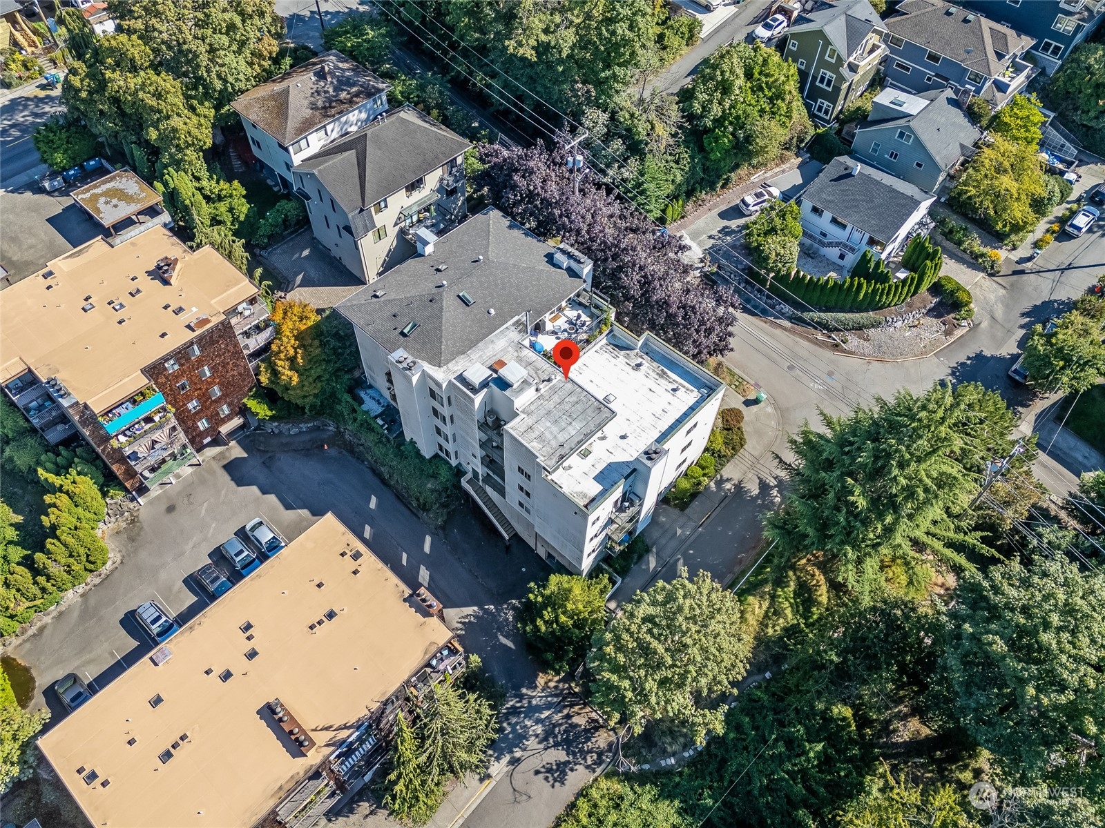 1110 West Howe Street, Unit 304 Seattle, WA 98119 - Photo 20 of 24 an aerial view of a house with a yard and a wooden deck