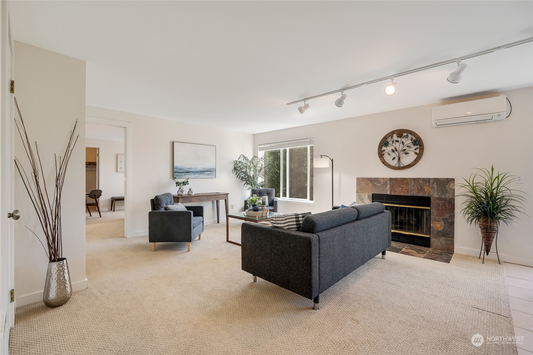 1110 West Howe Street, Unit 304 Seattle, WA 98119 - Photo 3 of 24 a living room with furniture a fireplace and a large window