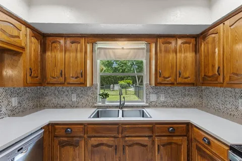 a kitchen with a sink and large window