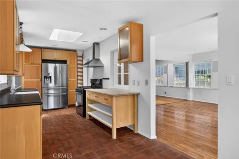 a kitchen with stainless steel appliances a refrigerator and a stove