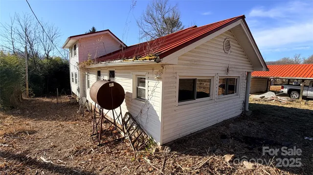 a backyard of a house with table and chairs