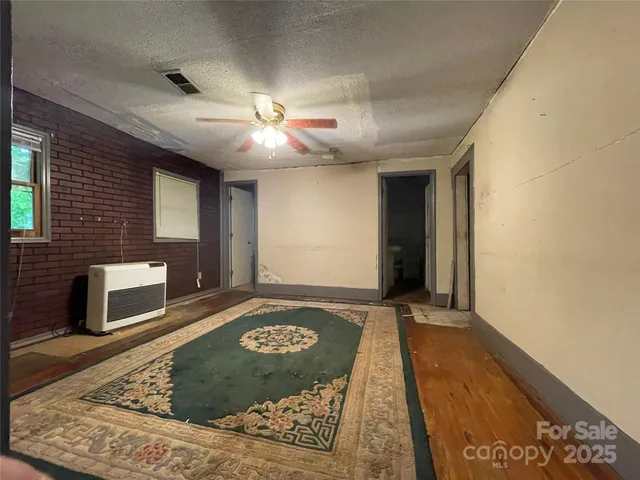a view of a hallway with a fireplace and a rug