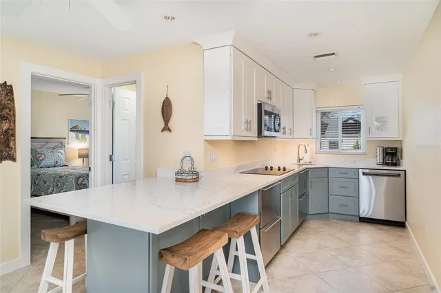 a living room with furniture and a dining table with kitchen view