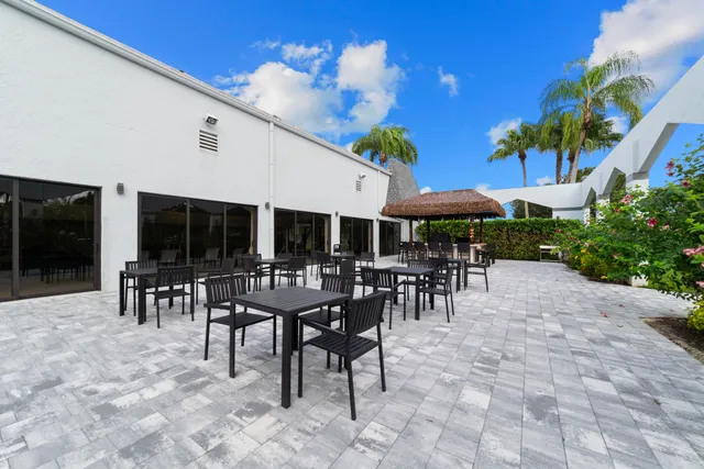 a view of a patio with dining table and chairs