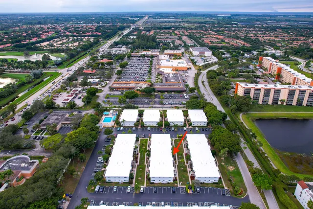 an aerial view of residential houses with outdoor space and trees