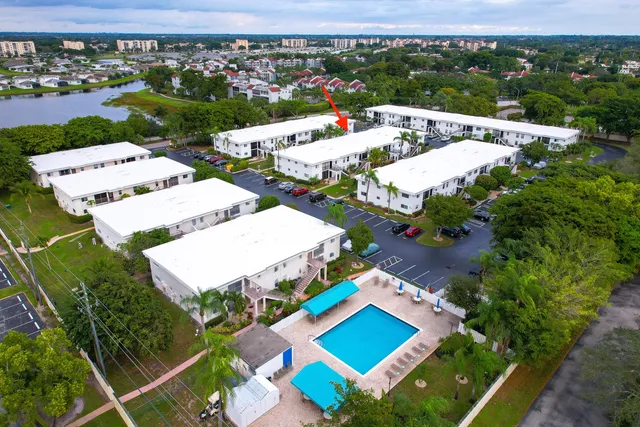 an aerial view of a house with swimming pool and ocean view