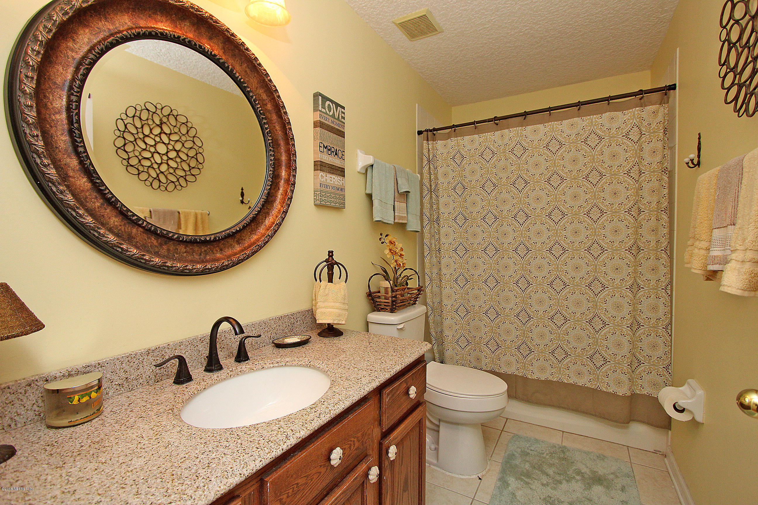 1232 Ribbon Road St. Johns, FL 32259 - Photo 19 of 27 a bathroom with a granite countertop toilet sink and mirror