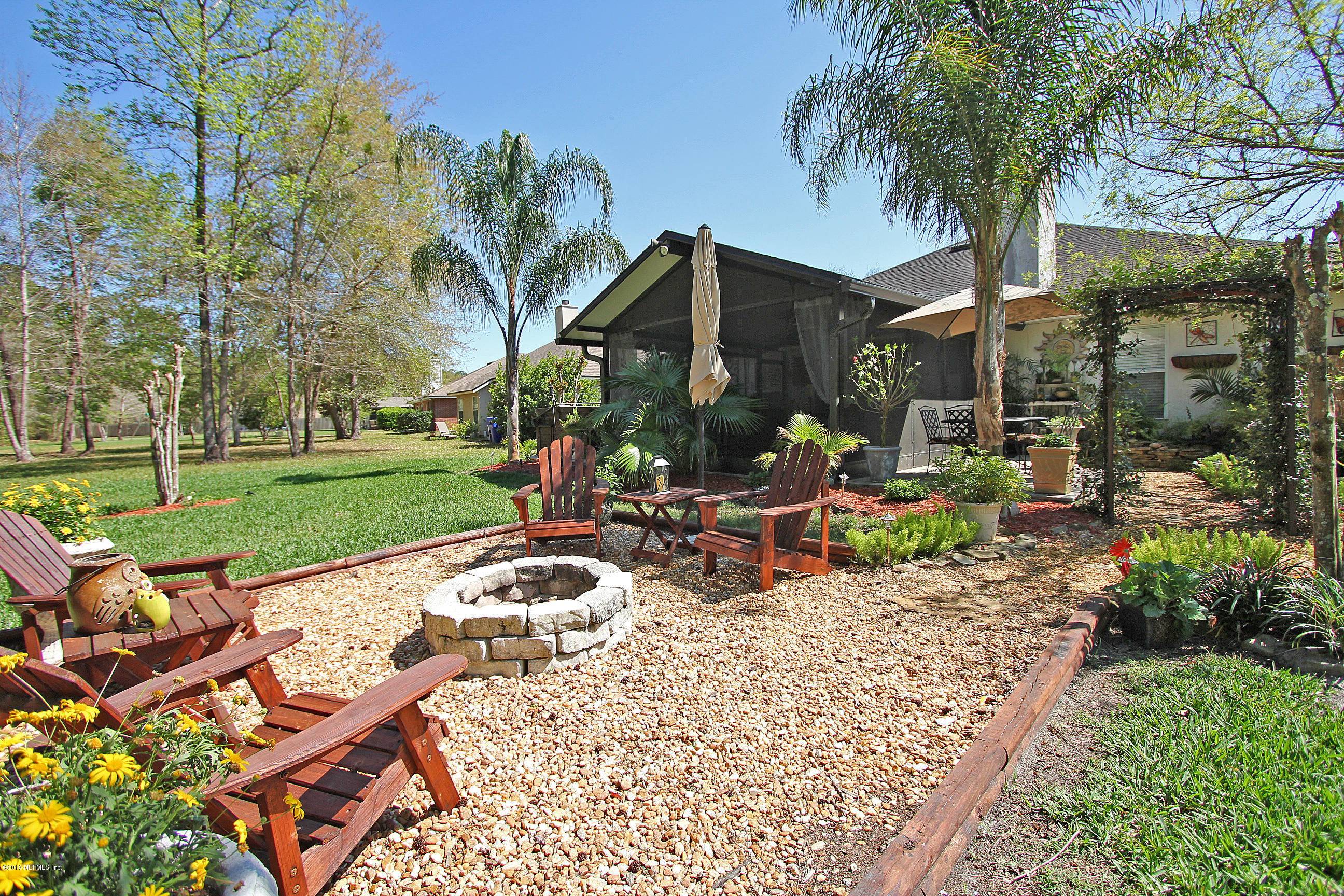 1232 Ribbon Road St. Johns, FL 32259 - Photo 24 of 27 a view of a patio with a table and chairs under an umbrella