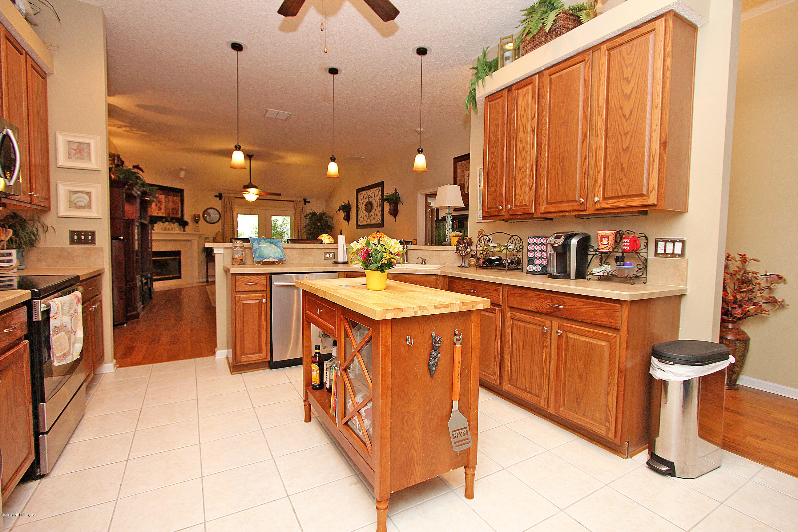 1232 Ribbon Road St. Johns, FL 32259 - Photo 7 of 27 a kitchen with stainless steel appliances granite countertop a sink counter space cabinets and a window