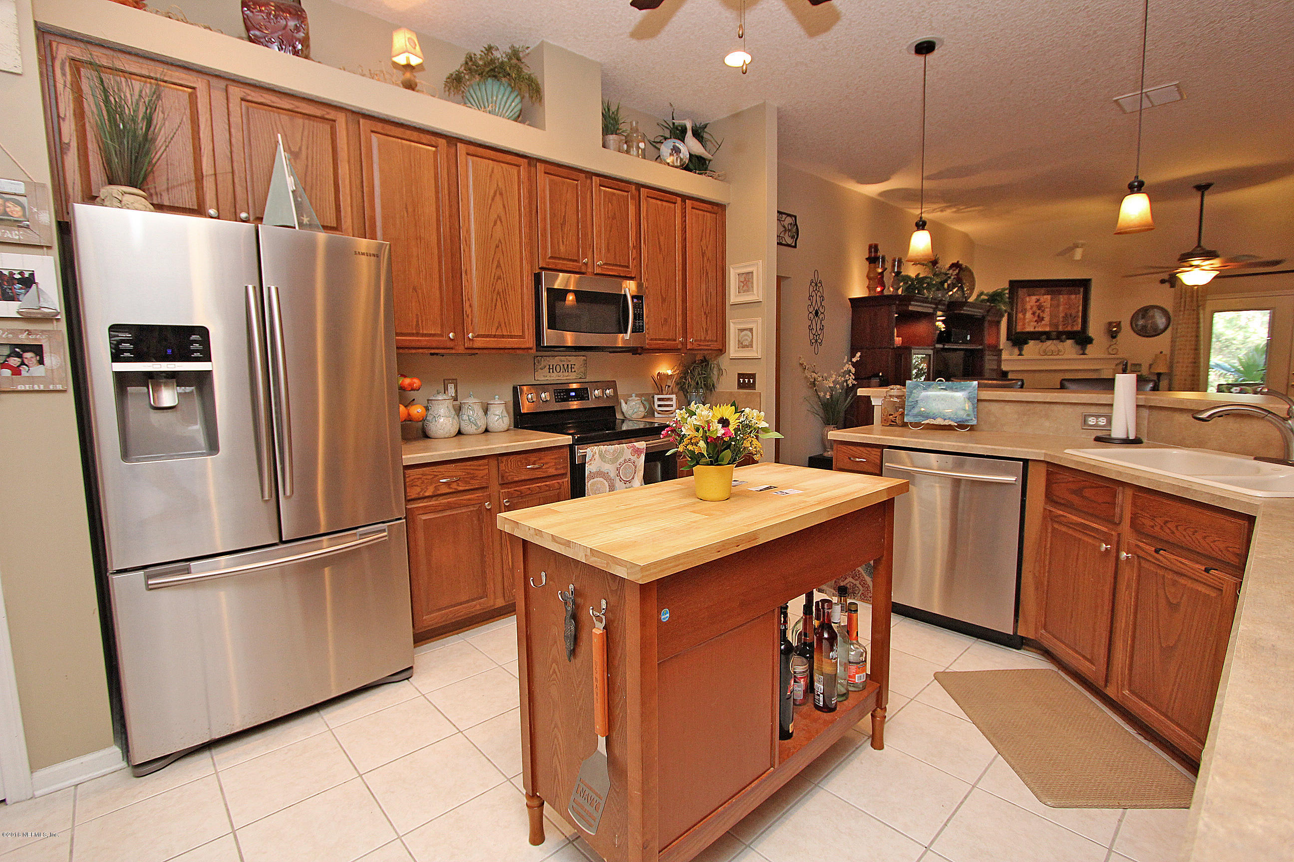 1232 Ribbon Road St. Johns, FL 32259 - Photo 8 of 27 a kitchen with stainless steel appliances granite countertop a refrigerator a sink dishwasher a stove with white cabinets and a refrigerator
