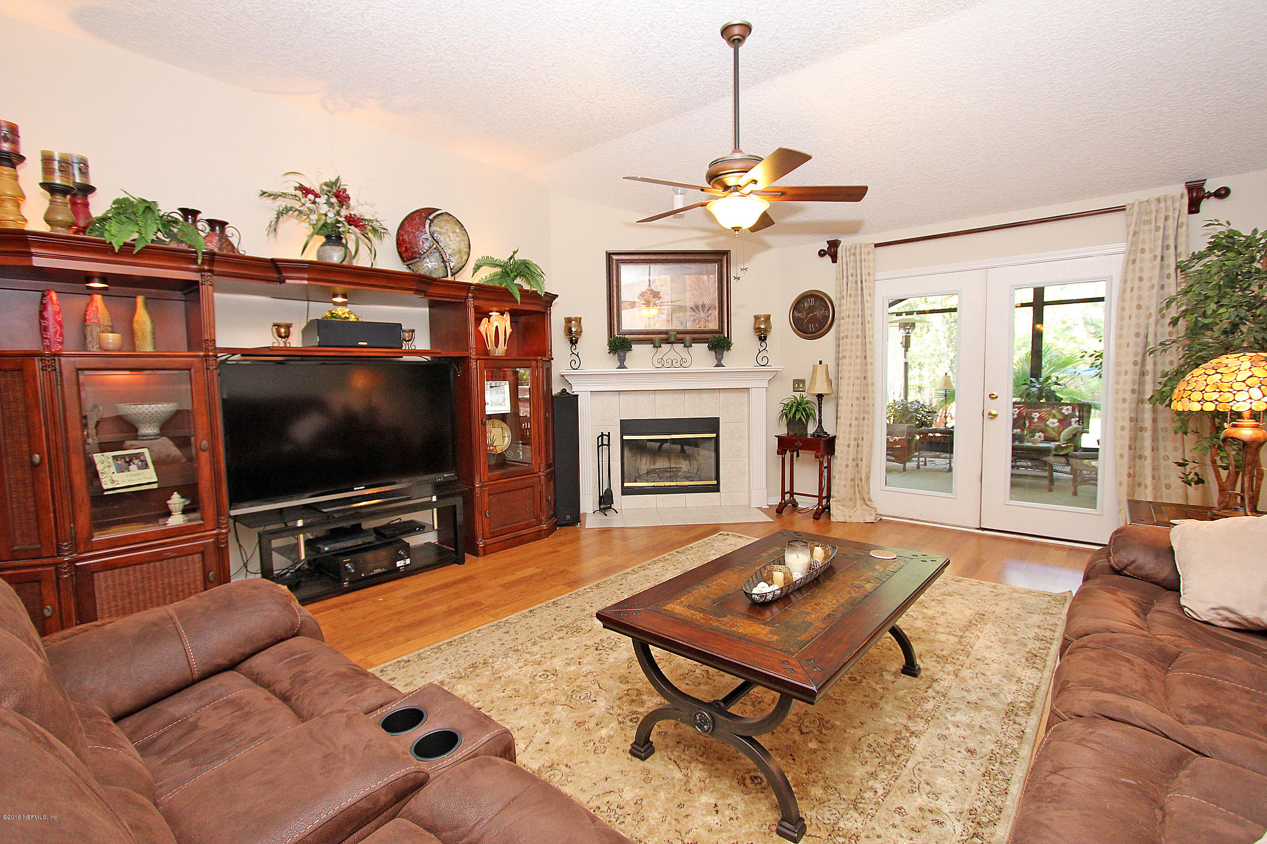 1232 Ribbon Road St. Johns, FL 32259 - Photo 10 of 27 a living room with furniture a flat screen tv and a fireplace