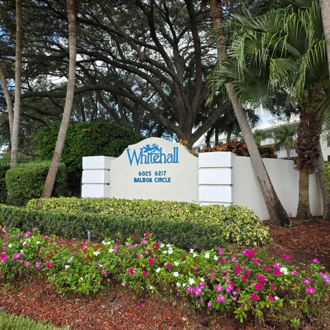 a sign that is in front of flowers