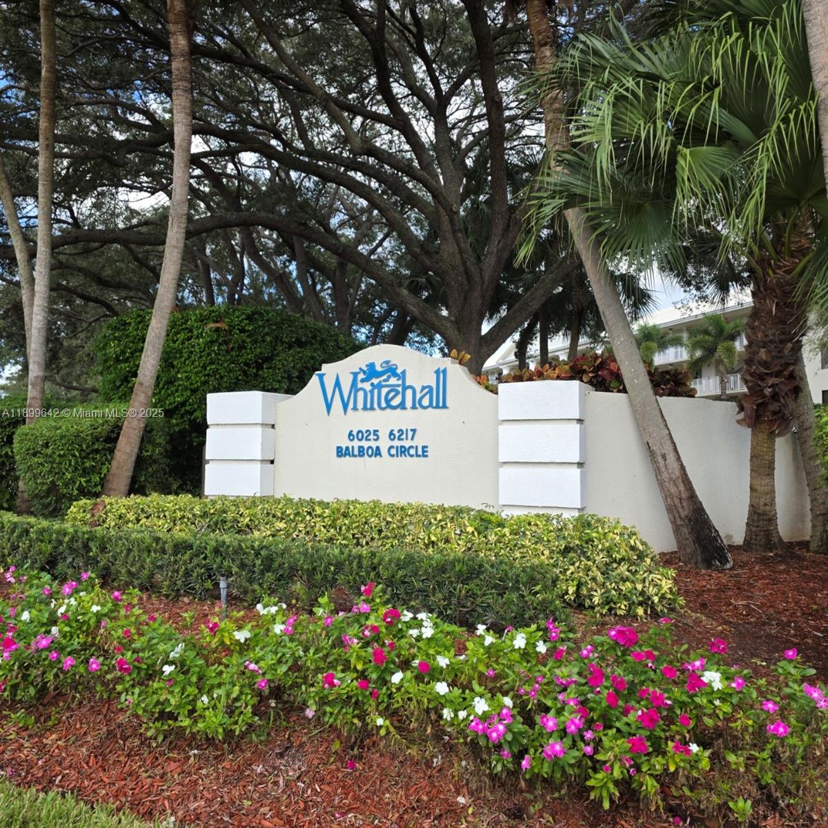 a sign that is in front of flowers