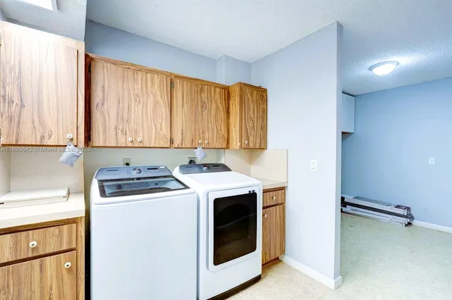a utility room with washer and dryer