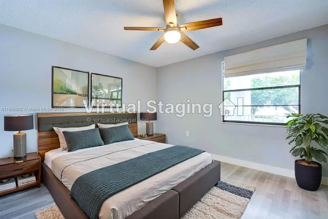 a bedroom with a large bed and a potted plant