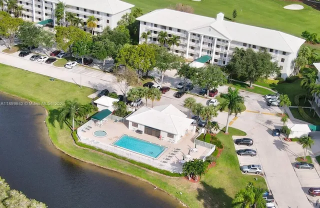 an aerial view of a house with a garden and swimming pool
