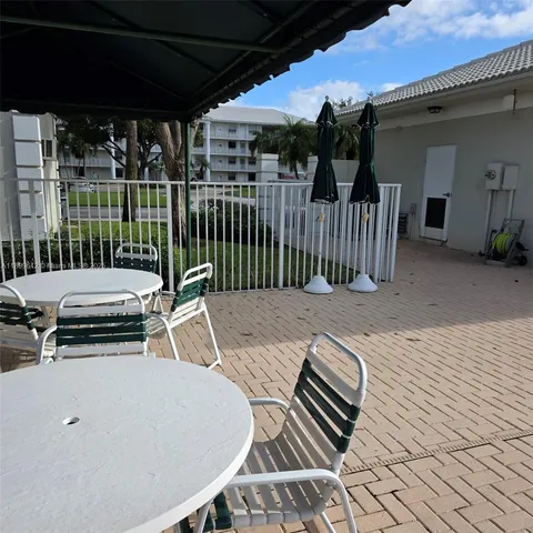 a view of balcony with wooden floor and outdoor seating