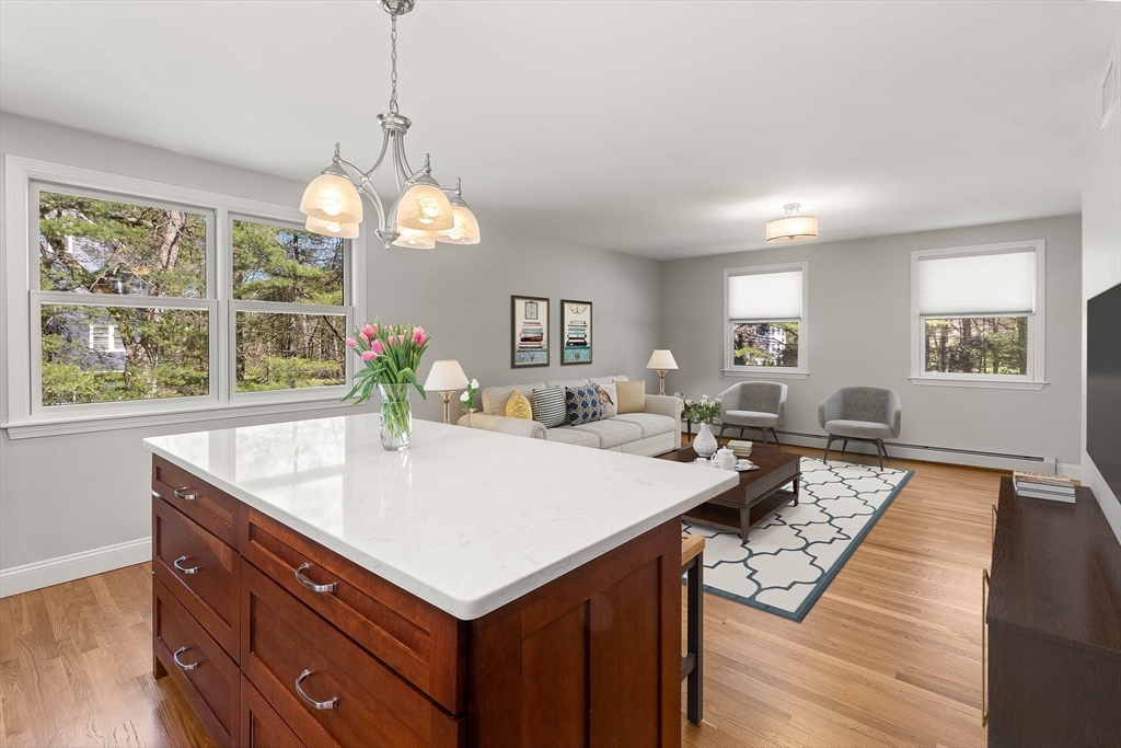 336 Sharpners Pond Road North Andover, MA 01845 - Photo 12 of 42 a very nice looking dining room with a large center island and couches