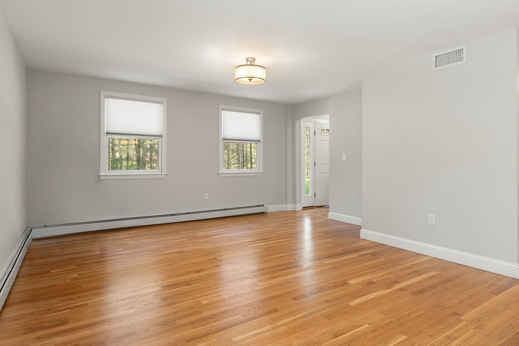 336 Sharpners Pond Road North Andover, MA 01845 - Photo 14 of 42 an empty room with wooden floor and windows