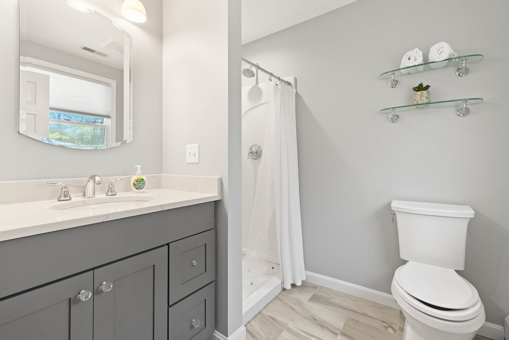 336 Sharpners Pond Road North Andover, MA 01845 - Photo 20 of 42 a bathroom with a toilet sink a mirror and vanity