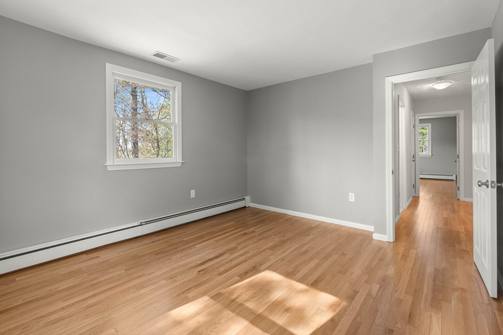 336 Sharpners Pond Road North Andover, MA 01845 - Photo 21 of 42 an empty room with wooden floor and windows