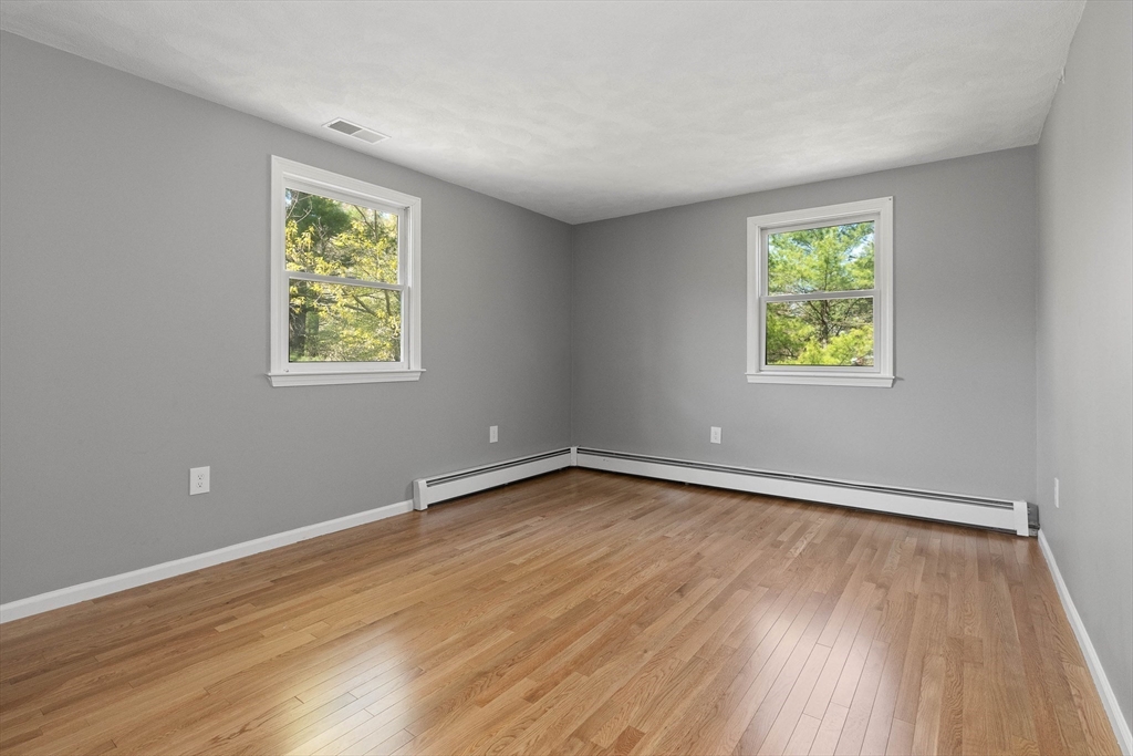 336 Sharpners Pond Road North Andover, MA 01845 - Photo 22 of 42 a view of an empty room with wooden floor and a window