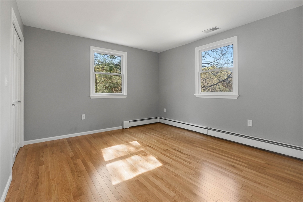 336 Sharpners Pond Road North Andover, MA 01845 - Photo 23 of 42 a view of an empty room with wooden floor and a window
