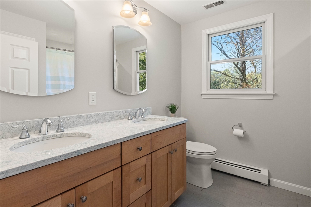 336 Sharpners Pond Road North Andover, MA 01845 - Photo 24 of 42 a bathroom with a granite countertop toilet sink and mirror