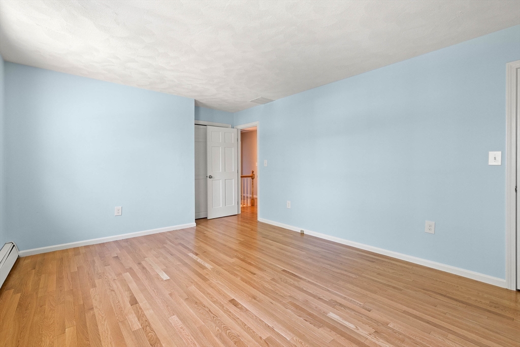 336 Sharpners Pond Road North Andover, MA 01845 - Photo 27 of 42 a view of an empty room with wooden floor