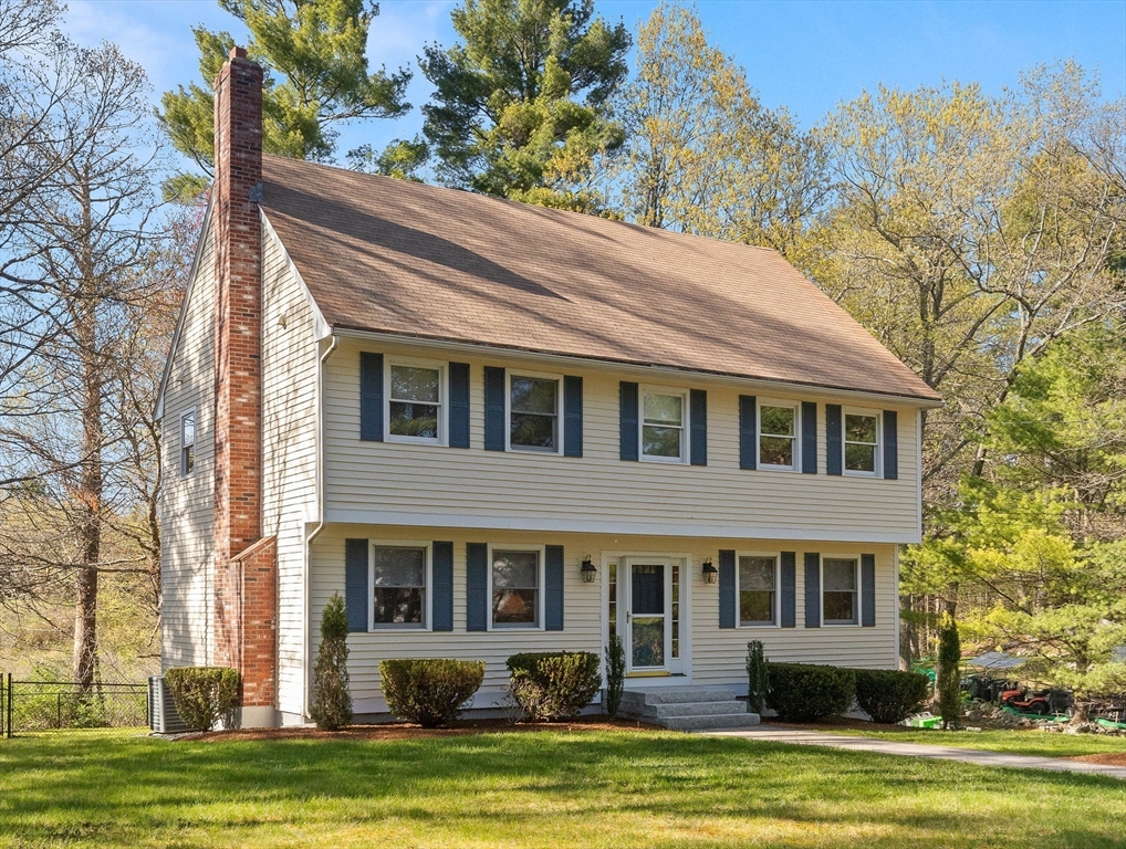 336 Sharpners Pond Road North Andover, MA 01845 - Photo 3 of 42 a front view of a house with a garden and trees
