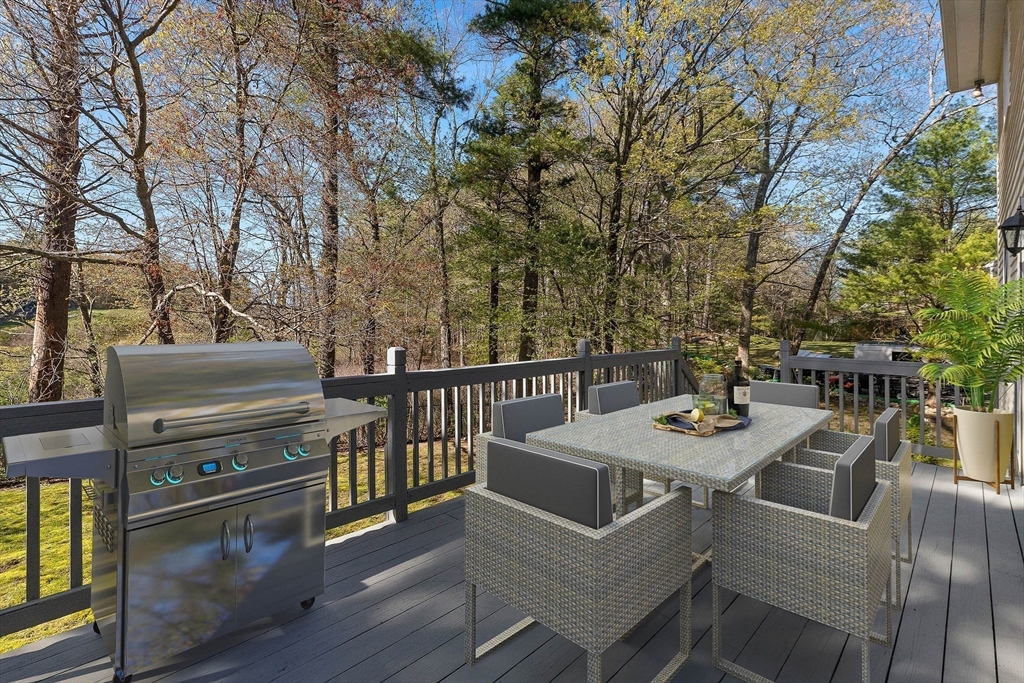 336 Sharpners Pond Road North Andover, MA 01845 - Photo 33 of 42 a view of a patio with table and chairs with wooden floor and fence