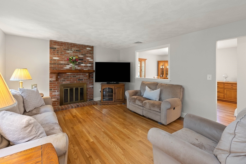 336 Sharpners Pond Road North Andover, MA 01845 - Photo 5 of 42 a living room with furniture a fireplace and a flat screen tv