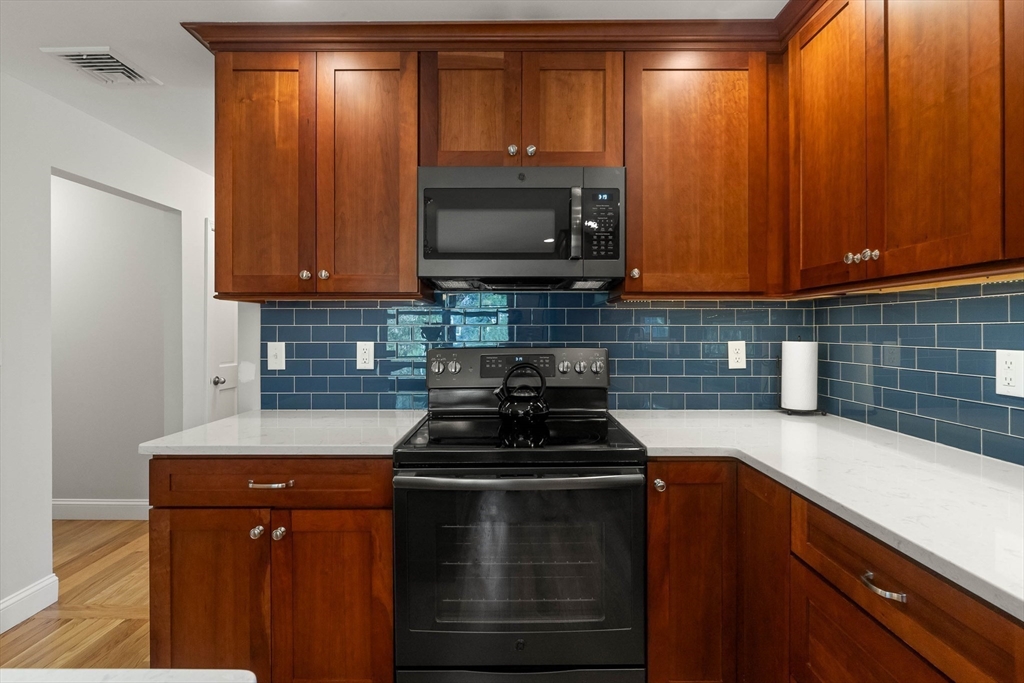 336 Sharpners Pond Road North Andover, MA 01845 - Photo 9 of 42 a kitchen with wooden cabinets and a stove top oven