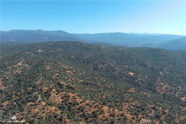 a view of a mountain range with lush green forest