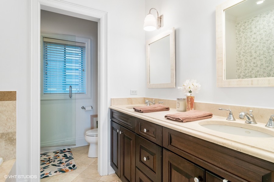 2002 West Barry Avenue Chicago, IL 60618 - Photo 11 of 25 a bathroom with a sink a toilet and a mirror