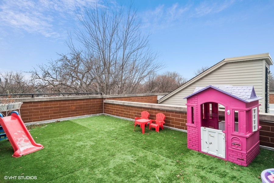 2002 West Barry Avenue Chicago, IL 60618 - Photo 20 of 25 a view of backyard with swimming pool and wooden fence
