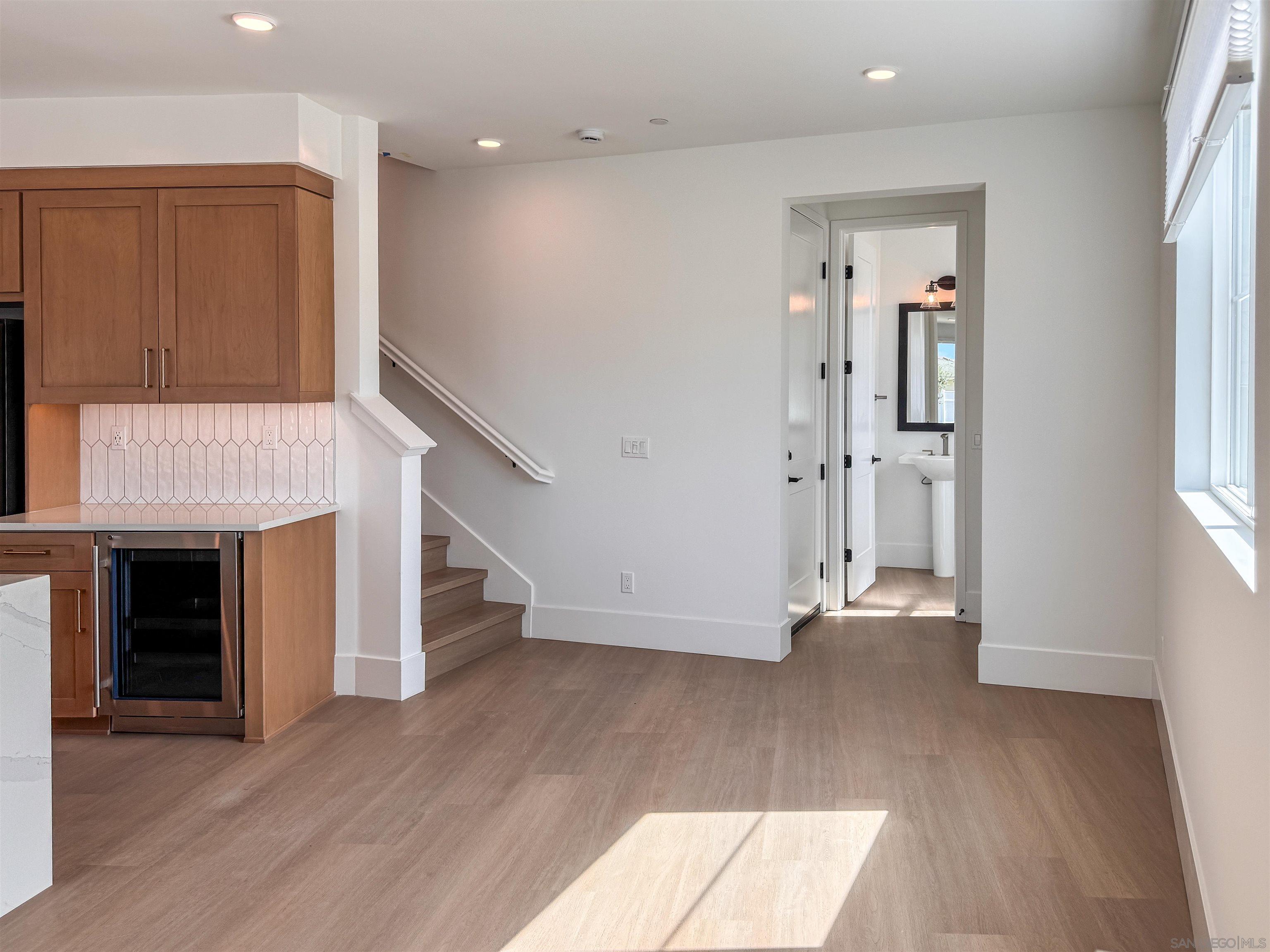 7290 Ponto Drive, Unit 7302 Carlsbad, CA 92011 - Photo 14 of 54 wooden floor in an empty room with a fireplace