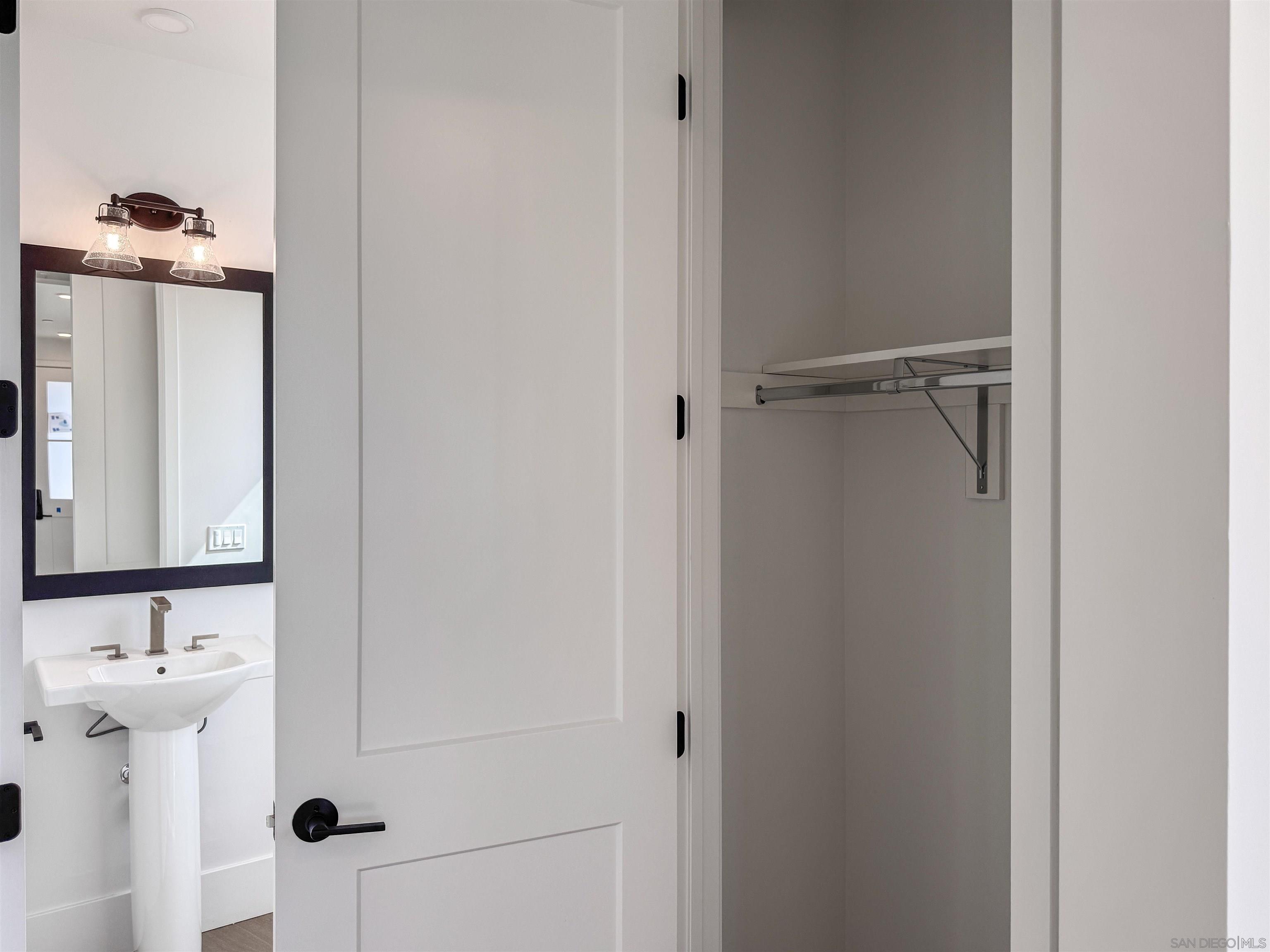 7290 Ponto Drive, Unit 7302 Carlsbad, CA 92011 - Photo 16 of 54 a bathroom with a sink and mirror
