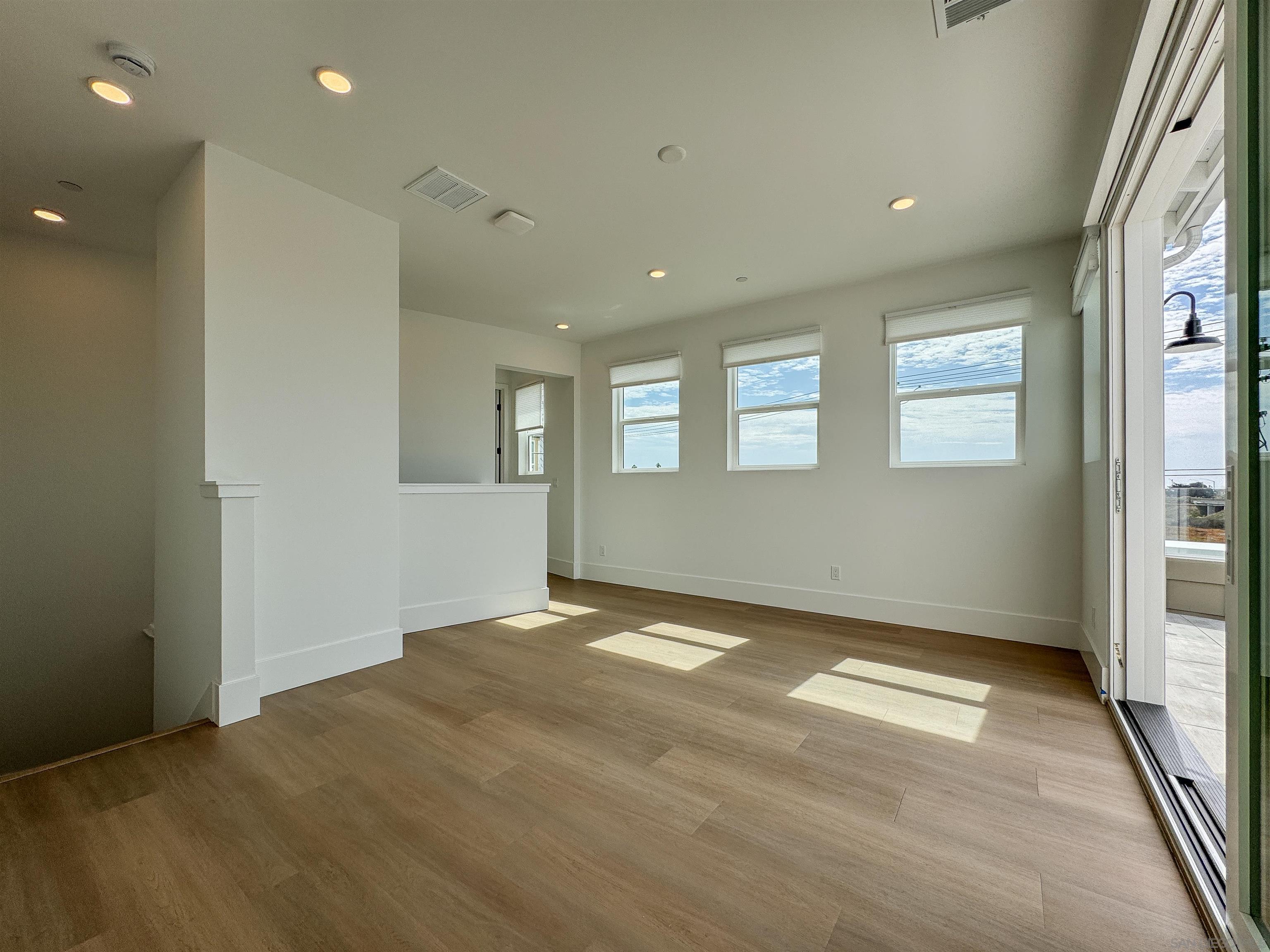 7290 Ponto Drive, Unit 7302 Carlsbad, CA 92011 - Photo 24 of 54 an empty room with windows