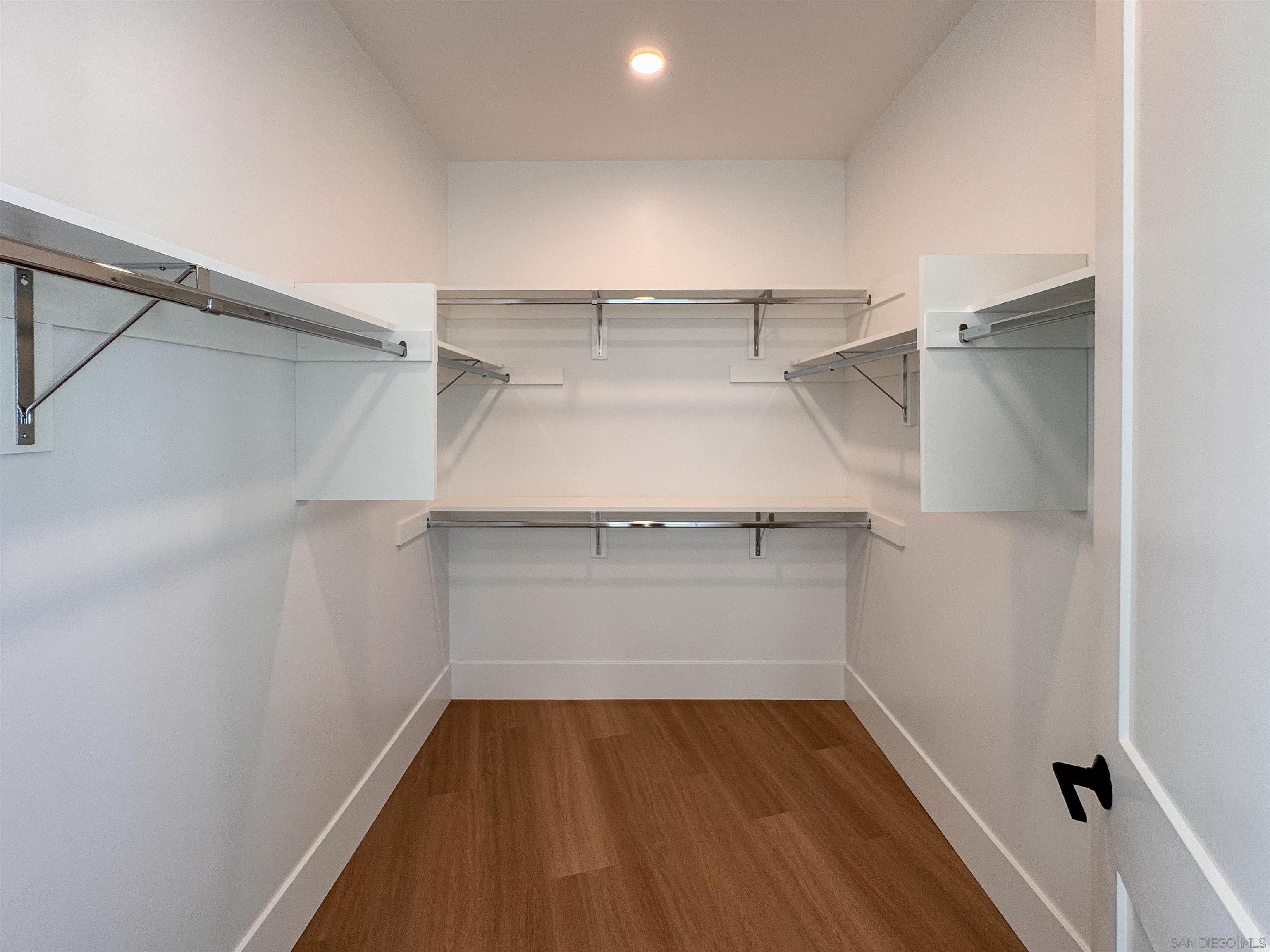 7290 Ponto Drive, Unit 7302 Carlsbad, CA 92011 - Photo 27 of 54 a view of walk in closet with empty racks