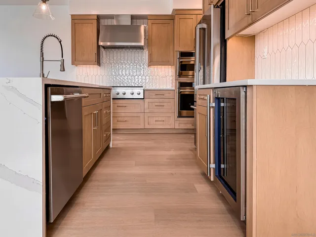 a kitchen with white cabinets and a refrigerator