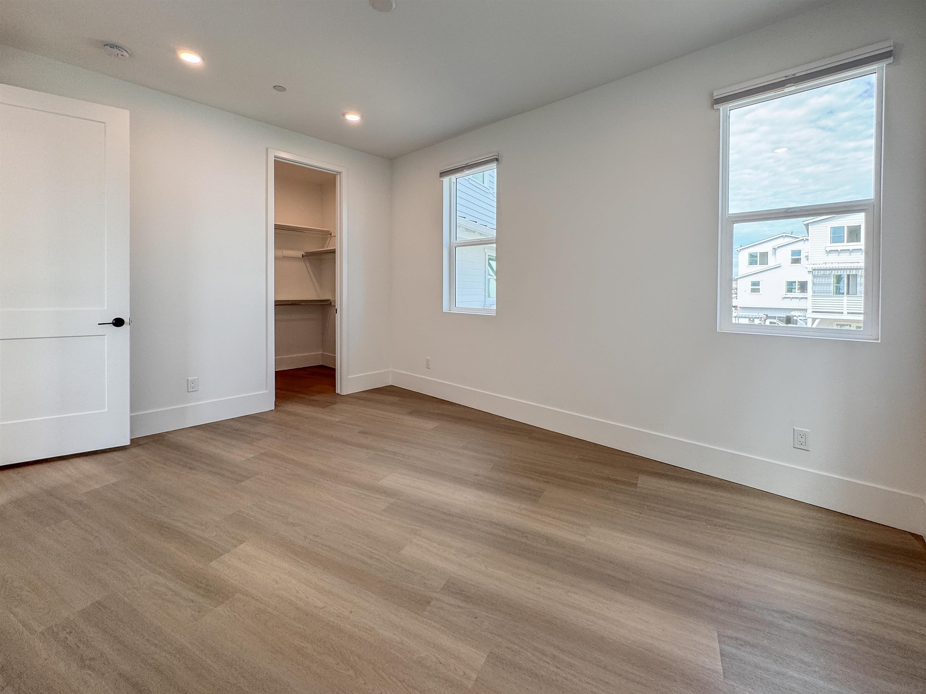 7290 Ponto Drive, Unit 7302 Carlsbad, CA 92011 - Photo 38 of 54 a view of empty room with wooden floor and window