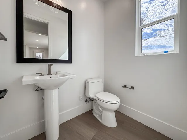 a bathroom with a shower sink and mirror