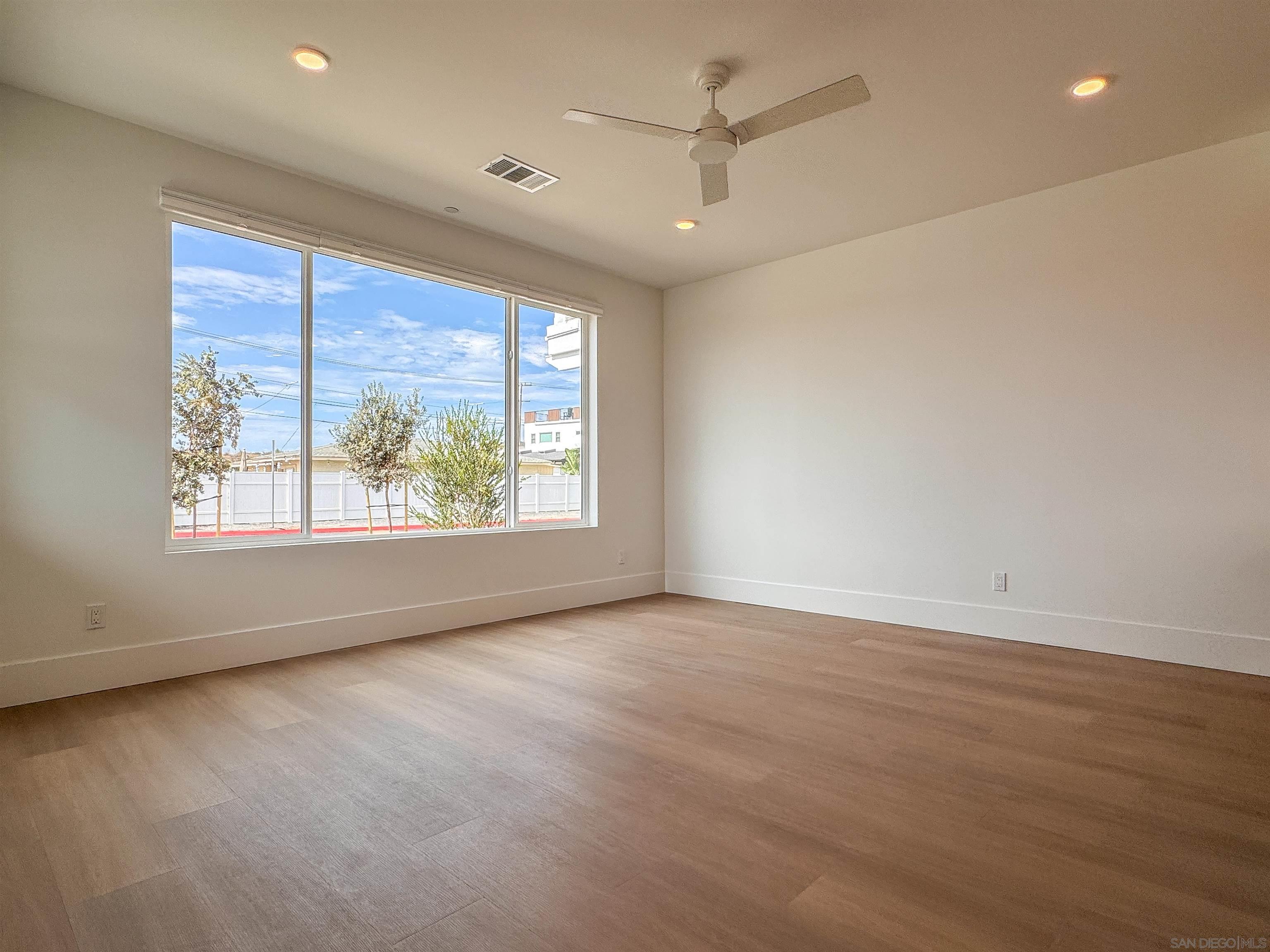 7290 Ponto Drive, Unit 7302 Carlsbad, CA 92011 - Photo 53 of 54 an empty room with wooden floor and windows