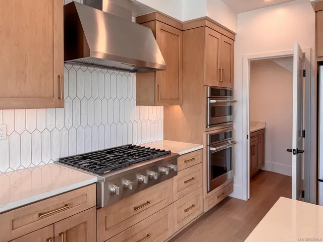 a view of storage and utility room with wooden floor