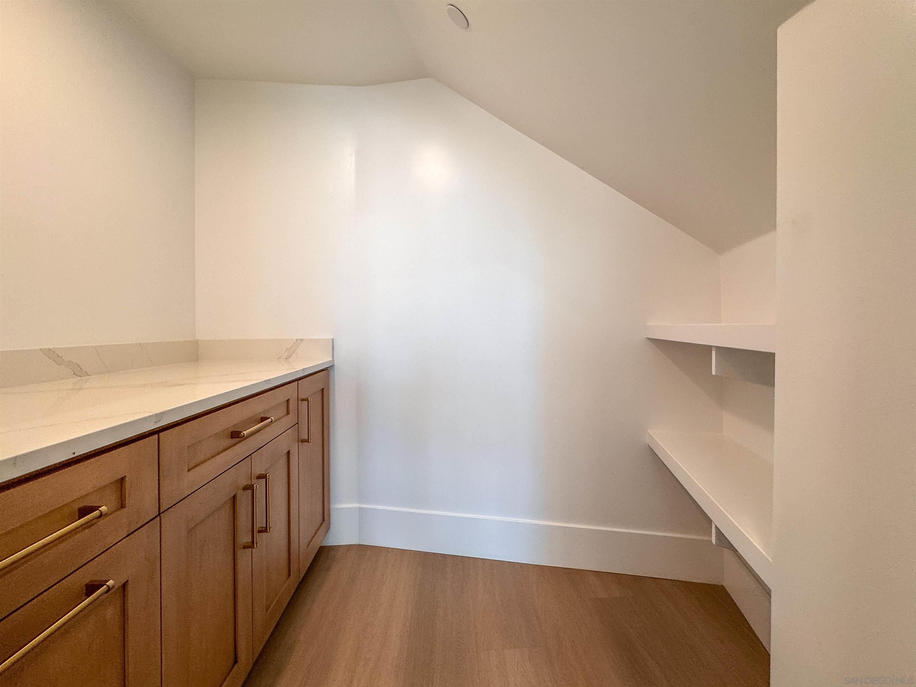 7290 Ponto Drive, Unit 7302 Carlsbad, CA 92011 - Photo 8 of 54 a view of storage and utility room with wooden floor