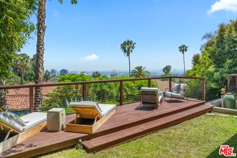 a view of a patio with couches and a potted plant